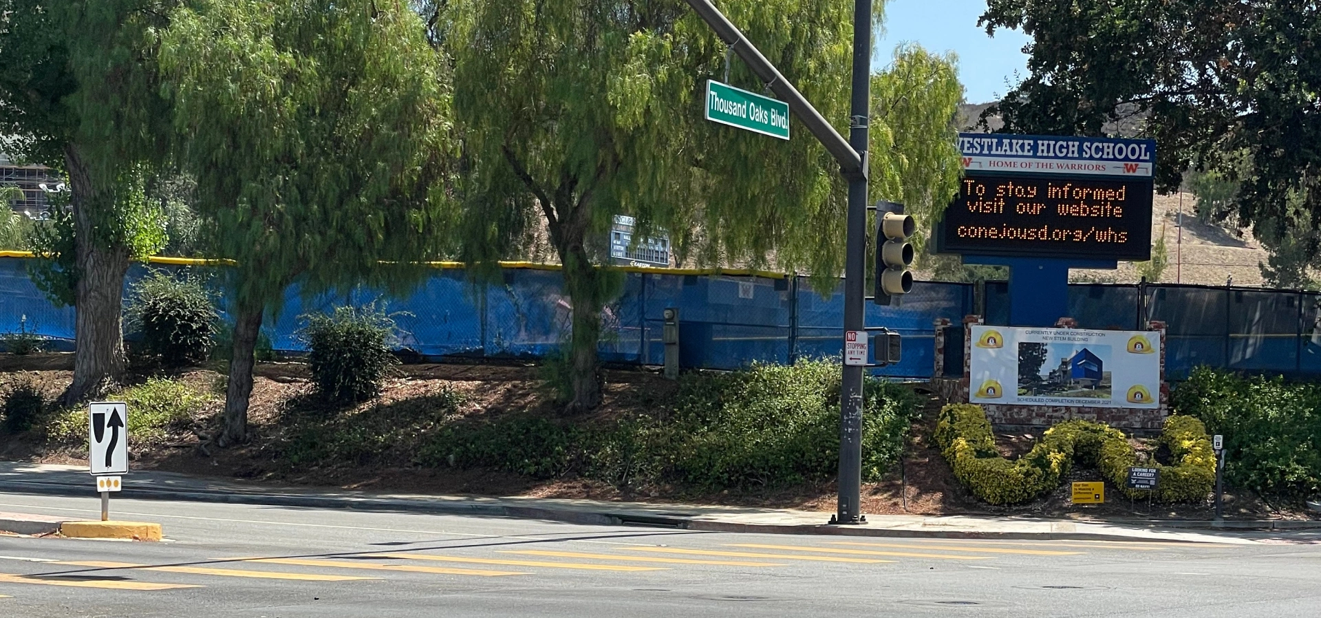 High school entrance with electronic signboard.