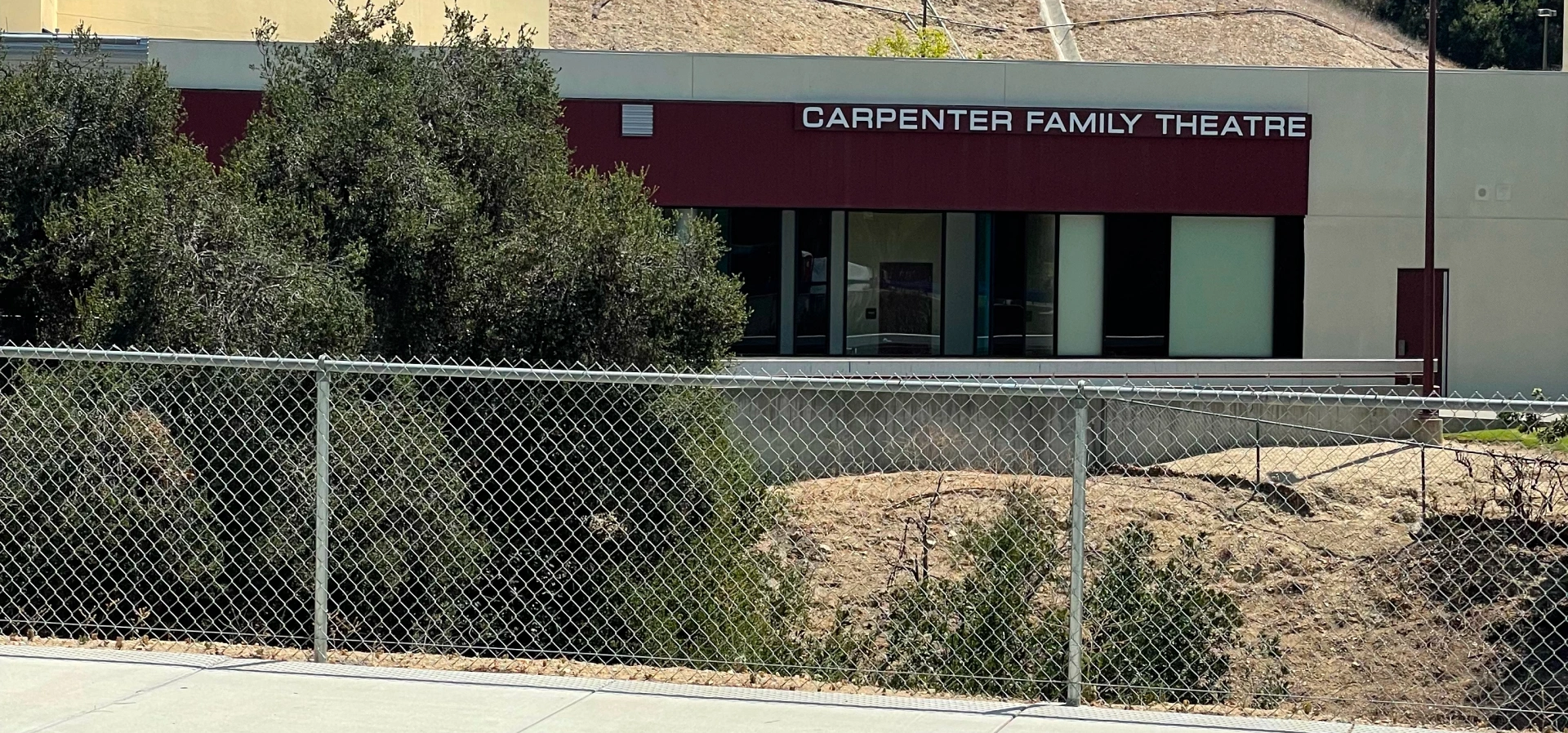 Carpenter Family Theatre building with fence.