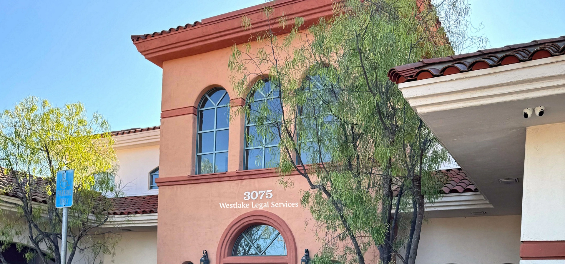 Two-story building with arched windows.